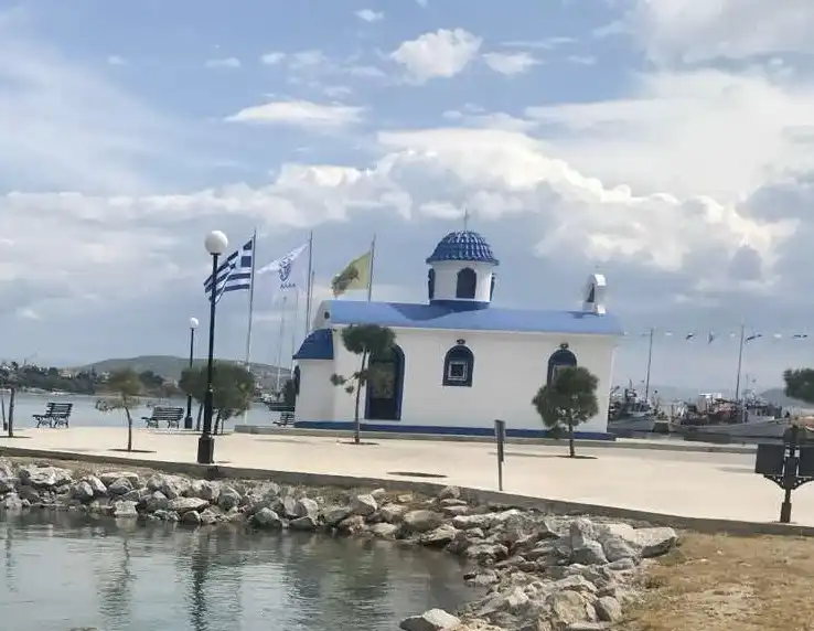 Picturesque small white chapel near the blue sea